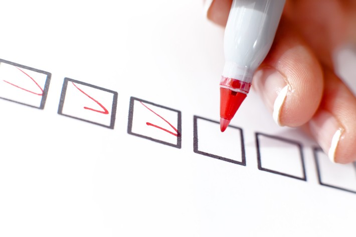 460518143 A woman selects and marks in the top box of a series.